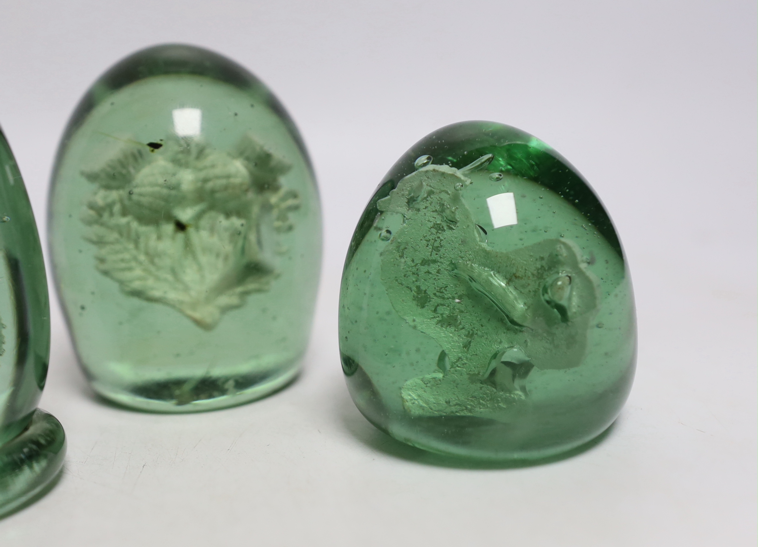 Five green glass dumps, including two with inset sulphides, tallest 9cm